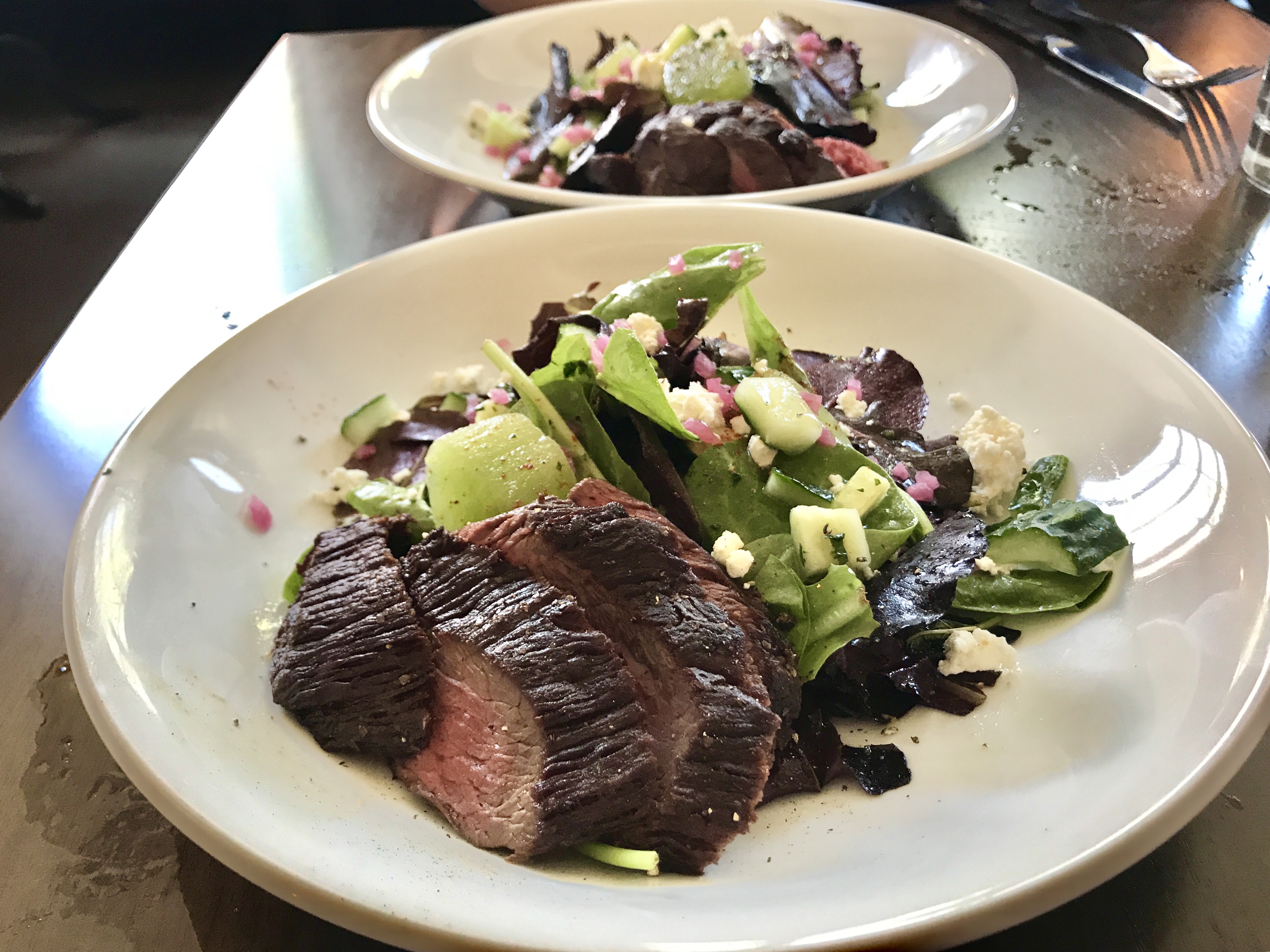 The Mustard and Melon Salad with perfectly cooked Arizona sirloin for lunch from Augstin Kitchen at Mercado San Augustin in Tucson, Arizona